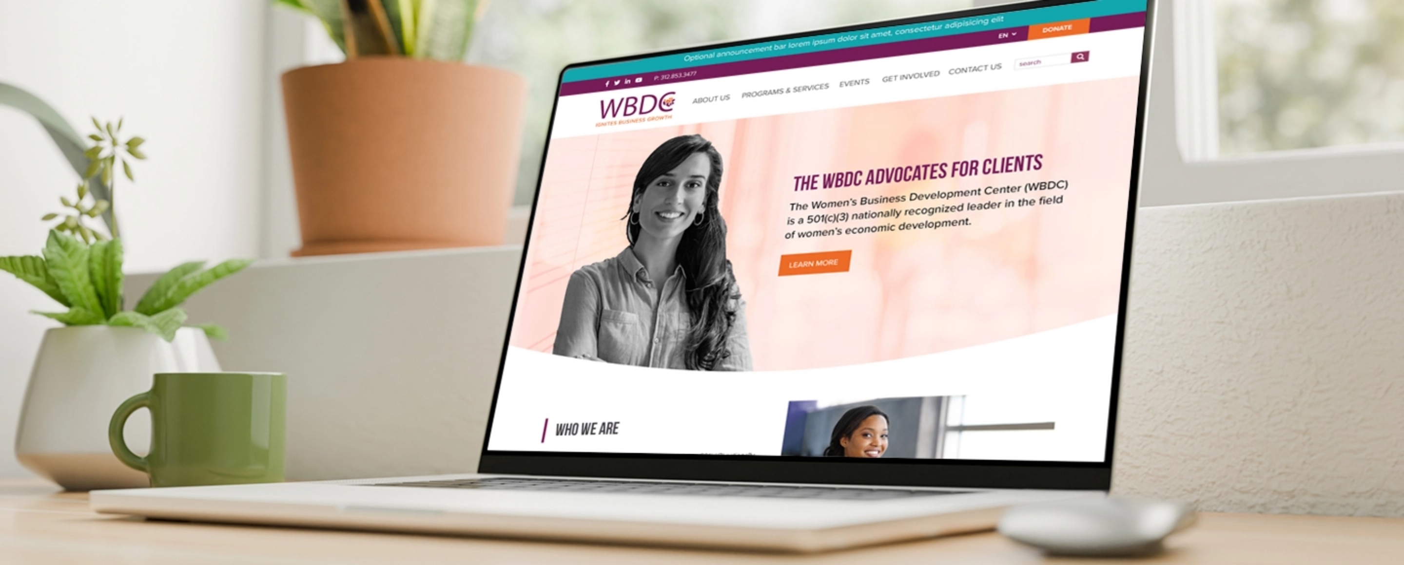 a laptop featuring the homepage for the Women's Business Development Center