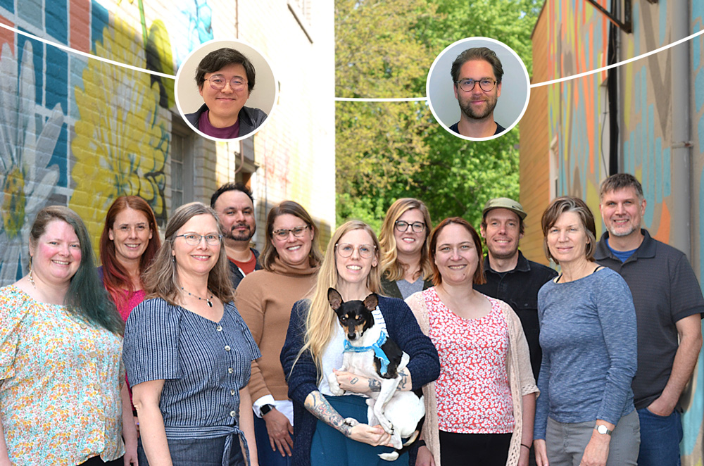 The staff of Greenleaf Media lined up posing with a dog in the alleyway